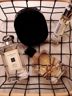 Image of four fragrance bottles in a wire basket for decoration