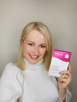 Lorna Weightman holding a box of Viviscal supplements