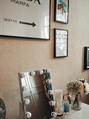 Image of wall art and desk with mirror sitting on it