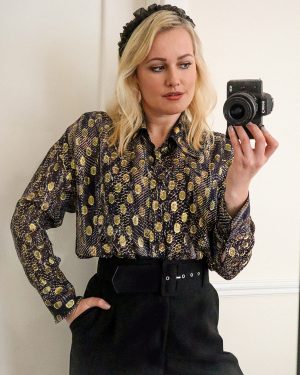 Lorna Weightman wearing Massimo Dutti printed shirt holding a camera