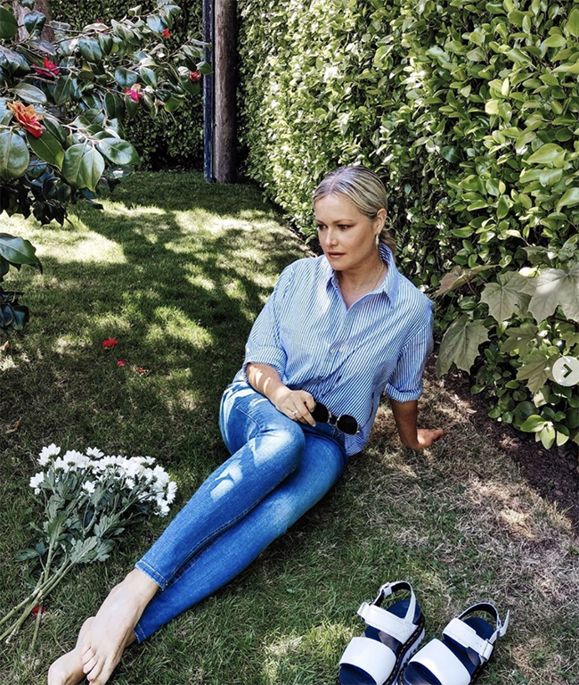 Lorna Weightman pictured in a blue shirt and jeans sitting in a garden