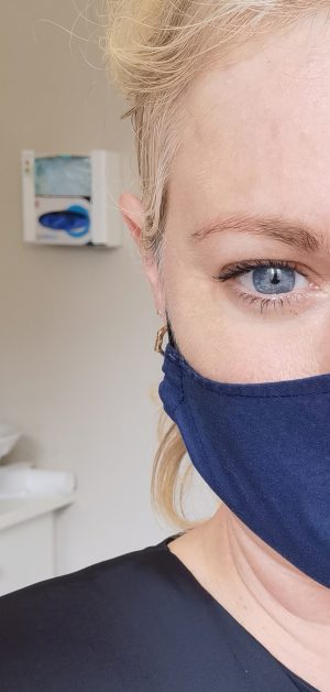 Close up image of Lorna Weightman wearing a blue face covering