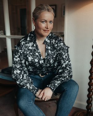 Lorna Weightman seated wearing black and white blouse and dark denim jeans as part of my favourite jeans blog post