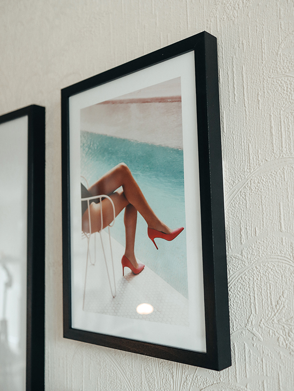 image of female showing legs wearing pink high heels and sitting by a pool as part of a gallery wall